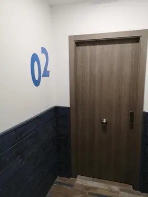 a door with the number on a wall at Monqar Playa Foz in Foz