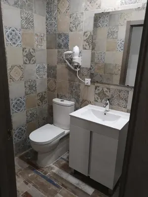 a bathroom with a toilet and a sink at Monqar Playa Foz in Foz