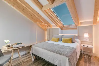 a bedroom with a large bed and a window at Hotel Pousada Real in Caldas de Reis