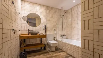 a bathroom with a toilet and a sink and a tub at Hotel Pousada Real in Caldas de Reis