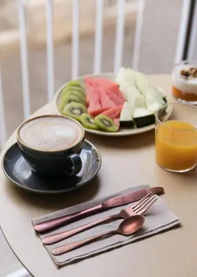 a table with a cup of coffee and a plate of food at Hotel Pousada Real in Caldas de Reis