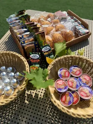 two baskets of food and drinks on a table at Casa Grande do Costureiro-Para Grupos en Portomarín con Terraza y Vistas in Portomarin