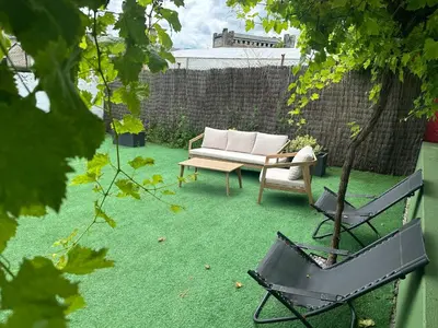 a garden with a couch and a chair on grass at Casa Grande do Costureiro-Para Grupos en Portomarín con Terraza y Vistas in Portomarin