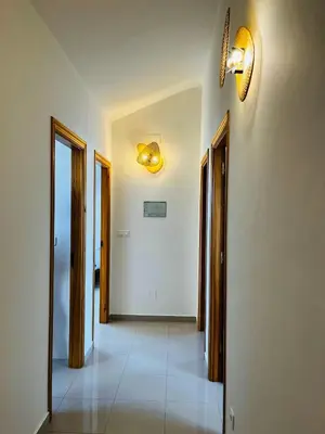 a hallway with doors and a light on the wall at Casa Grande do Costureiro-Para Grupos en Portomarín con Terraza y Vistas in Portomarin