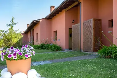 a pot of flowers in front of a building at Apartamentos El Guindal in Tapia de Casariego