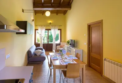 a living room with a table and a dining room at Apartamentos El Guindal in Tapia de Casariego