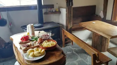 a table with bowls of food on top of it at Casa Turismo Rural O FILANDÓN in Suertes