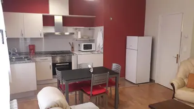 a kitchen with a table and a kitchen with a refrigerator at Camino Real in Molinaseca