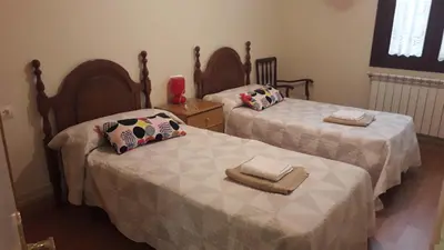 two beds sitting next to each other in a room at Camino Real in Molinaseca