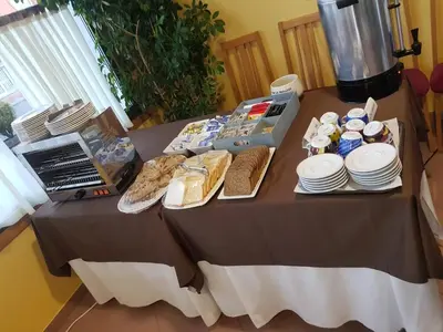 a table with food and plates on it at Hotel Bello in O Pino