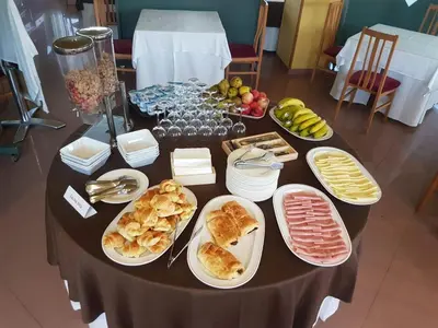 a table with plates of food on top of it at Hotel Bello in O Pino