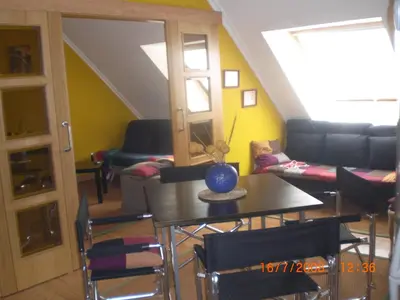 a living room with a table and a couch at La Mariña in Ribadeo