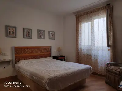 a bedroom with a bed and a window at La Mariña in Ribadeo
