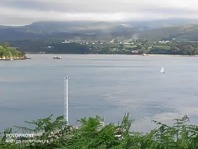a sailboat on a large body of water at La Mariña in Ribadeo