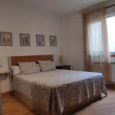 a bedroom with a bed and a window at La Mariña in Ribadeo
