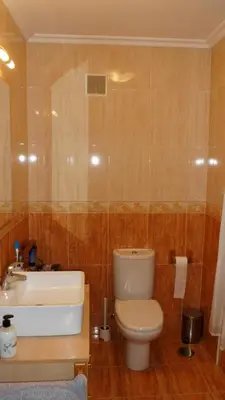 a bathroom with a toilet and a sink at La Mariña in Ribadeo