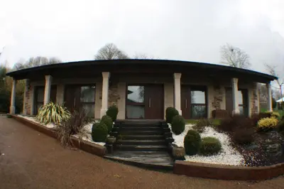 a house with a round roof with a staircase in front at Casa Barbadelo in Sarria