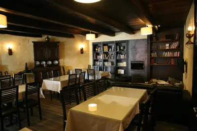 a restaurant with tables and chairs and bookshelves at Casa Barbadelo in Sarria