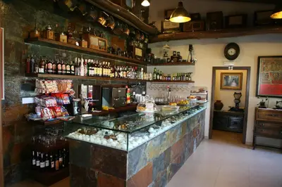 a bar in a room with a lot of alcohol at Casa Barbadelo in Sarria