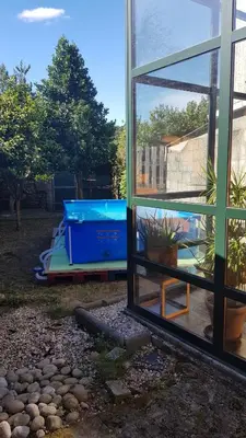 a window of a house with a pool in the yard at casa cacheiras in Teo