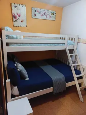 two bunk beds in a room with a blue bed at casa cacheiras in Teo