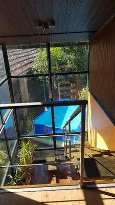 a view of a pool from the inside of a house at casa cacheiras in Teo