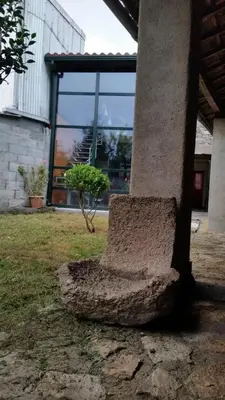 a stone bench sitting outside of a building at casa cacheiras in Teo