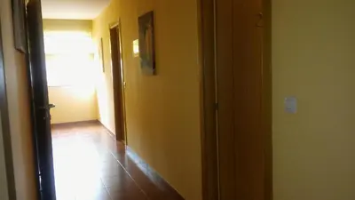 a hallway with a door leading to a room at Hostal-Meson Vilasante in Tríacastela