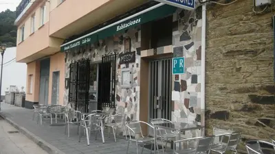 a group of tables and chairs outside of a building at Hostal-Meson Vilasante in Tríacastela