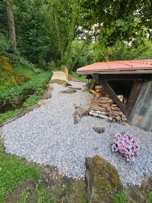 a gravel pathway with a picnic table and some flowers at A Pontiga I Casa Rural in Mezonzo