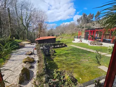 a garden with a building in the background at A Pontiga I Casa Rural in Mezonzo