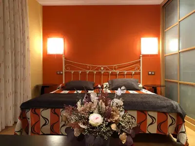 a bedroom with a large bed with flowers on it at Apartamentos Albariño in Vegadeo
