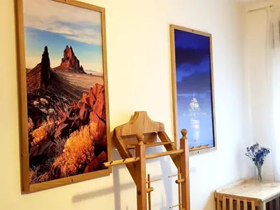 a picture on the wall next to a wooden chair at Villa Sabina 