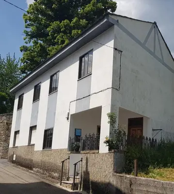 a white building with a fence in front of it at Villa Sabina 