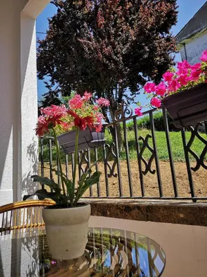 a table with a vase with flowers on a balcony at Villa Sabina 