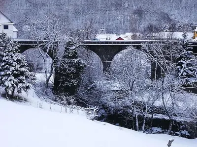 a bridge covered in snow with a train on it at Villa Sabina 