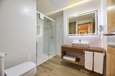 a bathroom with a sink and a shower at Casa Teodora by Adeloló in Arzúa