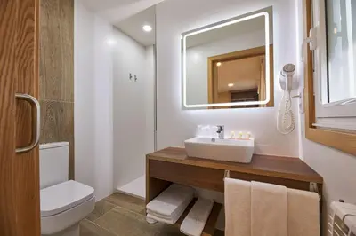 a bathroom with a sink and a toilet and a mirror at Casa Teodora by Adeloló in Arzúa