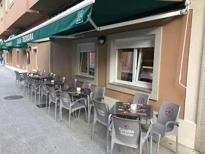 a row of tables and chairs outside of a restaurant at Casa Teodora by Adeloló in Arzúa