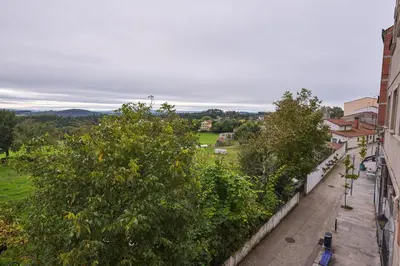 a view of a street from a building with trees at Casa Teodora by Adeloló in Arzúa