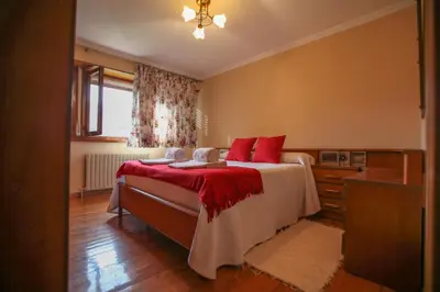 a bedroom with a bed with red pillows at Casa Rubieira in Sequeiro