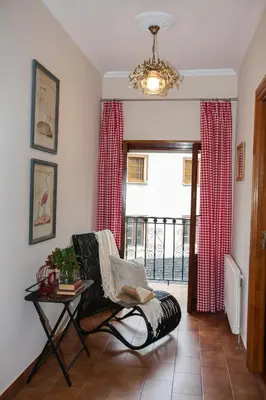 a living room with a chair and a window at Casa Rubieira in Sequeiro