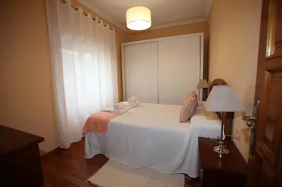 a bedroom with a white bed and a window at Casa Rubieira in Sequeiro