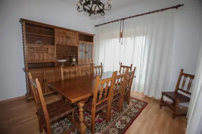 a dining room with a wooden table and chairs at Casa Rubieira in Sequeiro