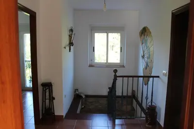 a room with a staircase with a window and a stair case at Casa Da Pallota in Moraña