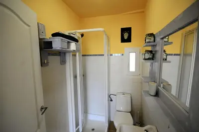 a bathroom with a toilet and a sink and a shower at San Pedro in Cangas de Foz