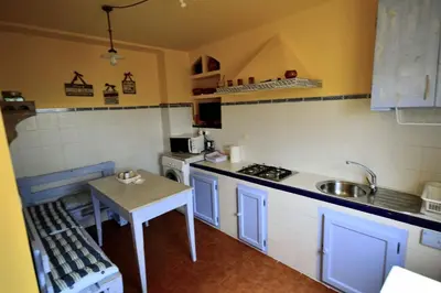 a small kitchen with a table and a sink at San Pedro in Cangas de Foz