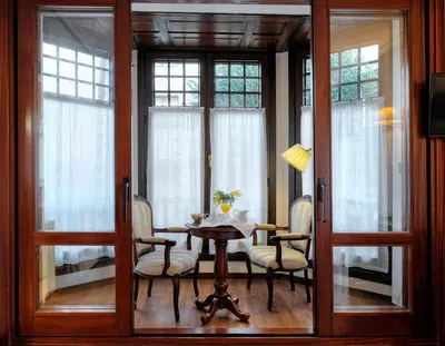 a dining room with a table and chairs and windows at Palacio Arias in Navia