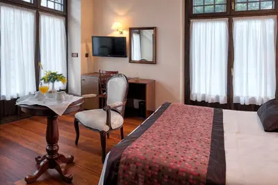 a hotel room with a bed and a table and a chair at Palacio Arias in Navia