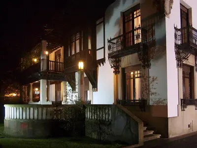 a building with balconies and lights on the side of it at Palacio Arias in Navia